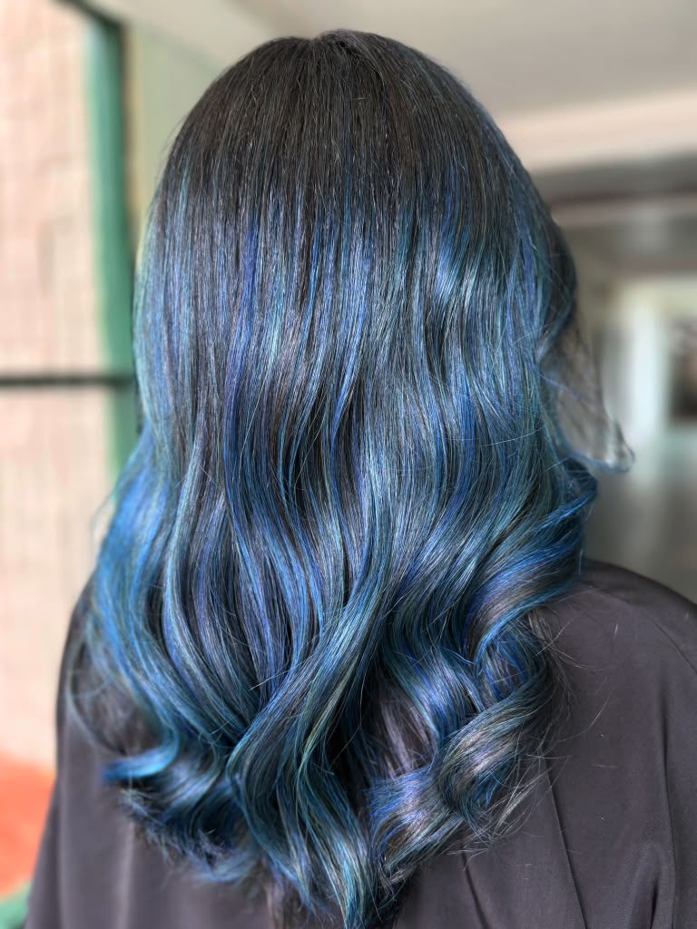 Blue and teal vivid colour melting from a natural black root